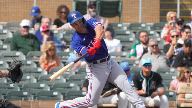 Feb 27, 2024; Salt River Pima-Maricopa, Arizona, USA; Texas Rangers left fielder Wyatt Langford (82) hits against the Arizona Diamondbacks during the first inning at Salt River Fields at Talking Stick.